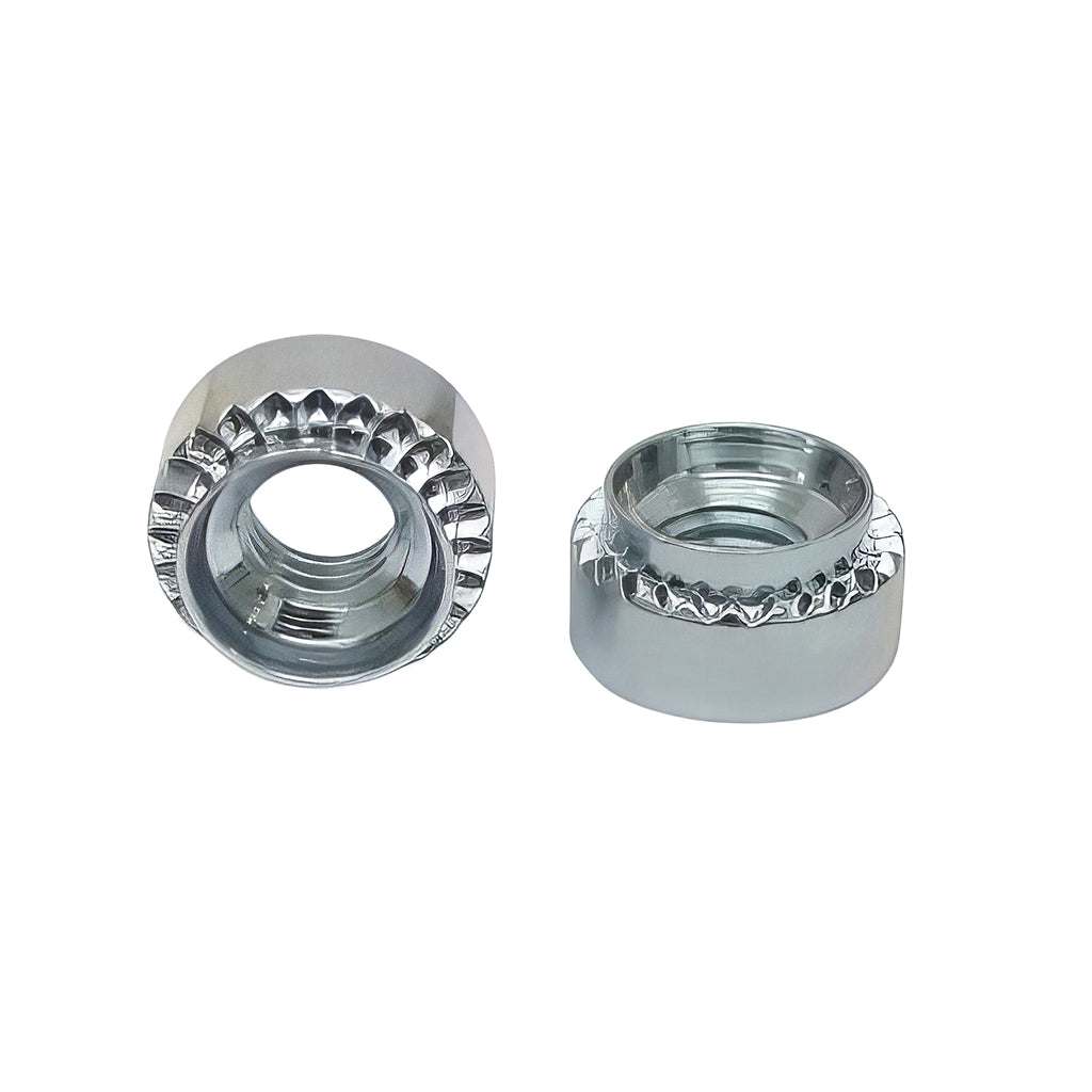 Close-up of rivet bushes used for creating female threads in sheet metal with hexagon and round outer shapes