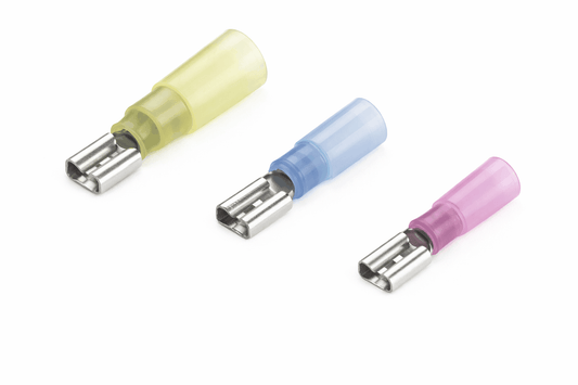 Heat shrink female spade terminals with brass conductor, tin plating, copper sleeve, and waterproof insulation for secure electrical connections